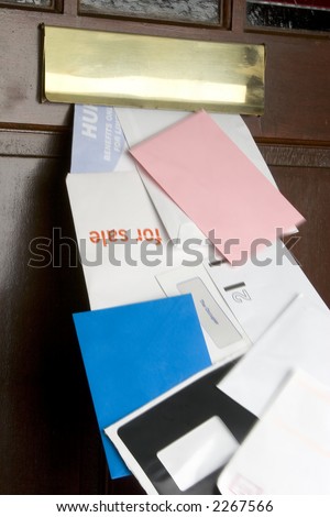 Stream of junk mail coming through the letter box, motion blur on mail.