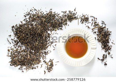 White cup of tea with dried tea leaf on the white background