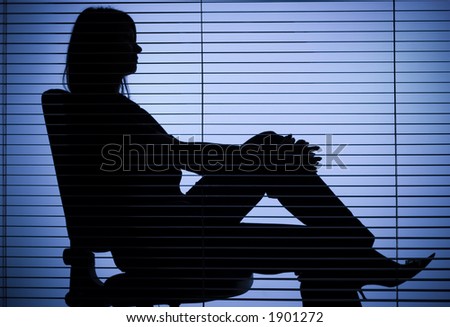 isolated on blue silhouette of woman sitting in the office (focus on the blind)