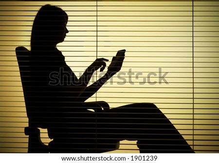 silhouette of sitting woman with calculator over the blind
