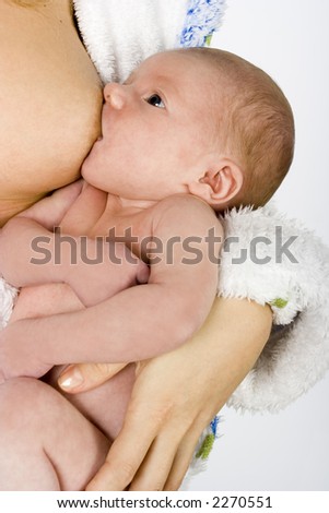 woman feeding baby in her arms