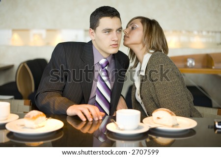 Man and Woman at the Bar. Short Depth of Focus (On Their Faces). Woman\'s wispering to man\'s ear.