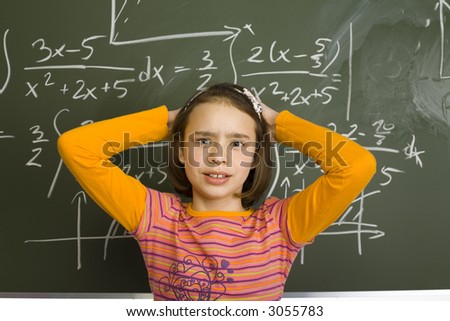 11yo girl is holding her head. There\'s pain on her face. Behind her there\'s greenboard with maths integrals.