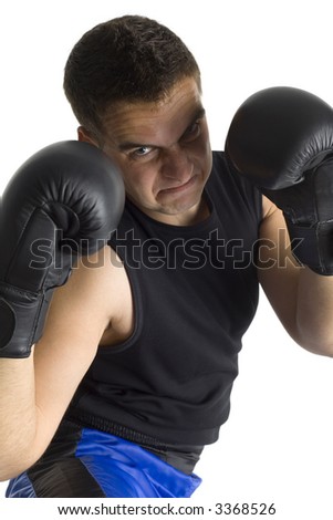 Angry young man in black boxing gloves with shady face, looking at camera. Isolated on white in studio.