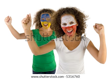 Happy female fans with painted Polish and Slovakian flags on faces. They're looking at camera. Focus on first person. They're on white background. Front view.