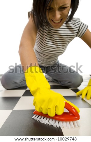 stock photo Young woman in yellow rubber gloves kneeling and scrubs the