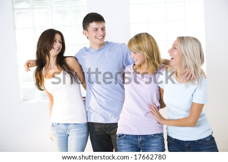 Group of young people. They\'re standing and looking like good friends. Front view.
