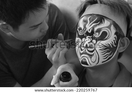 Kaohsiung, TAIWAN - APRIL 4th :Before the temple fair, Face painting teacher use a brush to help The Eight of the Dead World be painted on APRIL 4th, 2014 in Kaohsiung, Taiwan, Asia.