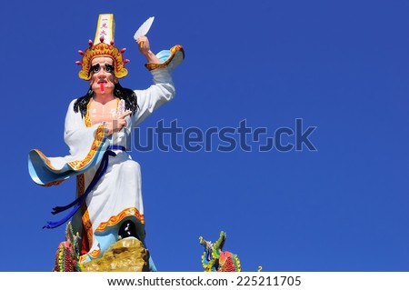 Taiwan traditional costume on the roof of the temple police painted stone statue