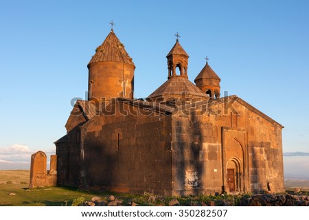 Sunset colors on armenian ancient Saghmosavank church with blue sky behind