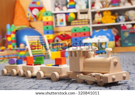 wooden train in the play room and many toys
