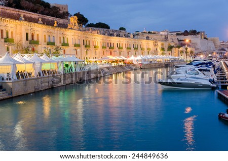 MALTA, VALLETTA-NOVEMBER 15 2015: Evening at the Valletta Waterfront. The Valletta waterfront is a popular tourist attraction full of cafes and restaurants