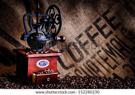 This image is of coffee beans, coffee grinder, and coffee beans bag in background.