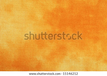 Macro of orange tie-dyed fabric for background use.