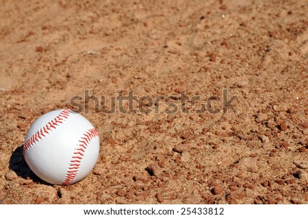 Baseball on dirt infield with copy space.