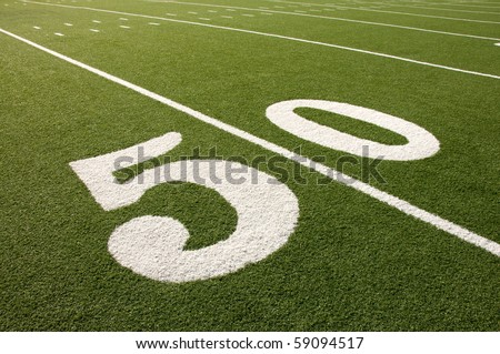 Closeup of 50 yard line on American football field.