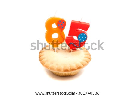 cupcake with eighty five years birthday candle on white background