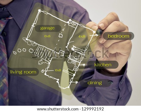 Man sketching a small house plan