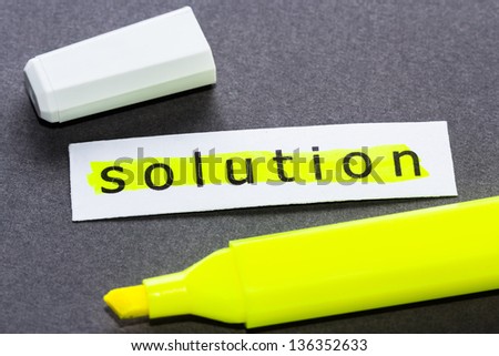 Solution word on piece of paper with yellow highlight pen