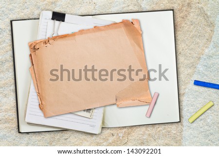 Paper and notebook with color pastel sticks on stone background