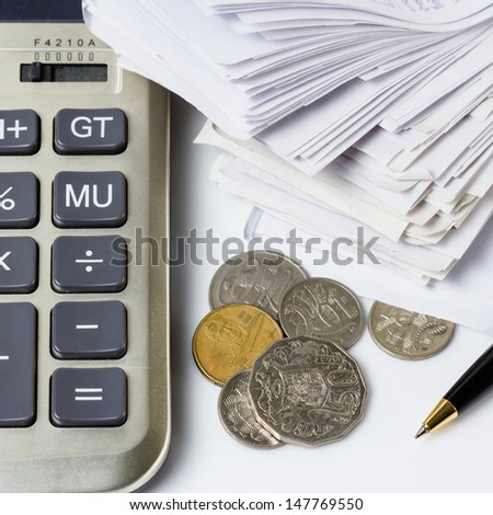 Australian coins with part of calculator, receipts and pen