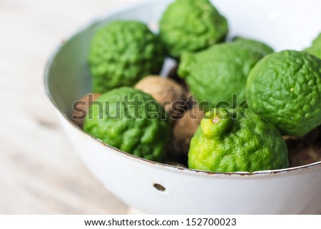 Kaffir lime or leech lime in metallic white bowl