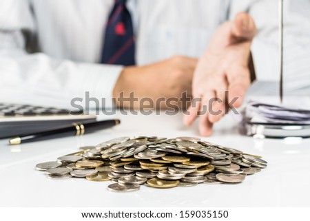 Pile of coins with hand that  gesture something as money savings, investment or any financial concept