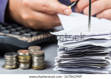 Bills in paper nail with hand working on background