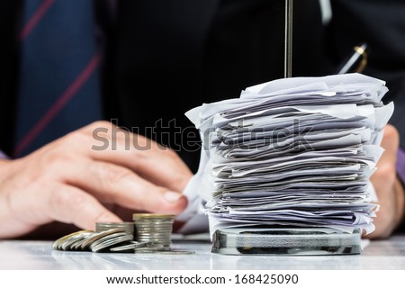 Businessman working with bills in paper nail