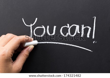 Hand writing message to motivate people with chalk