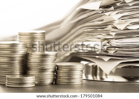 Heap of coins and receipts in paper nail