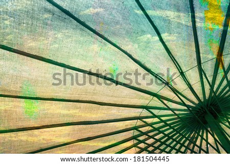 Abstract design of bamboo umbrella with clouds and sky in retro color style