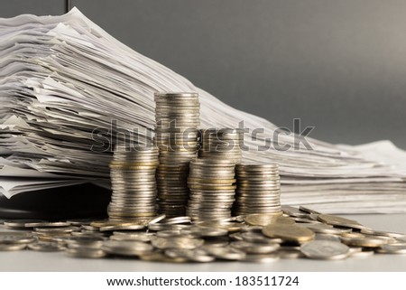 Heap and pile of coins with receipts in paper nail
