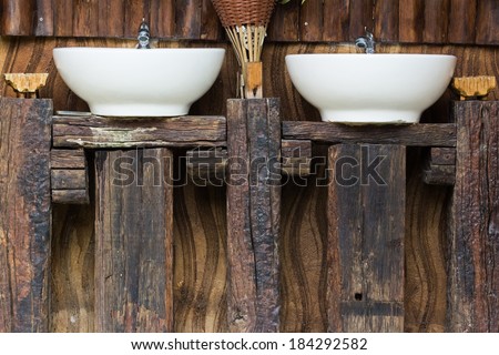 Wood counter and hand washing sinks outside the toilet