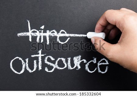 Hand delete Hire word on blackboard with chalk for business outsourcing concept