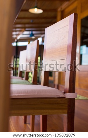 Wood chair with seat pillow on the wood porch