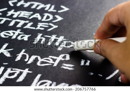Closeup hand writing computer source code with chalk