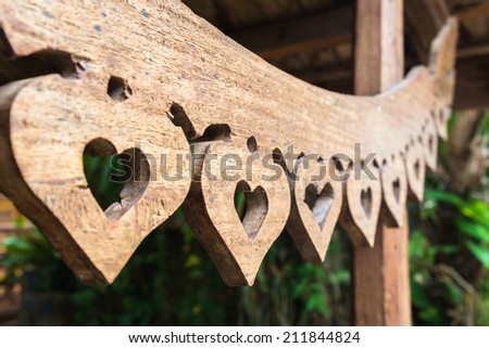 Carved wood in heart shape pattern decorated over the gate of house