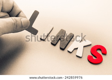 Finger pick a wood letters of Links word