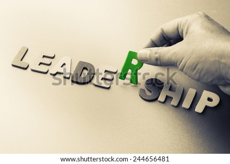 Hand arrange wood letters as Leadership word
