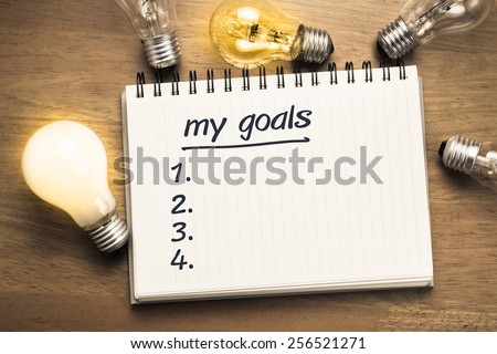 My Goals as memo on notebook with many light bulbs
