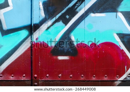 Color spray as messy graffiti on metal, part of bogie