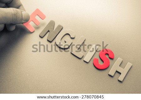 Hand arrange wood letters as English word