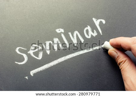 Hand writing Seminar topic on chalkboard