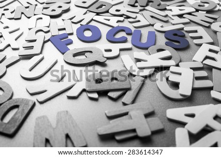 Color Focus word in scattered black and white wood letters