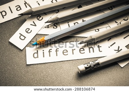 Closeup piece of paper pile with color pencil, Different concept