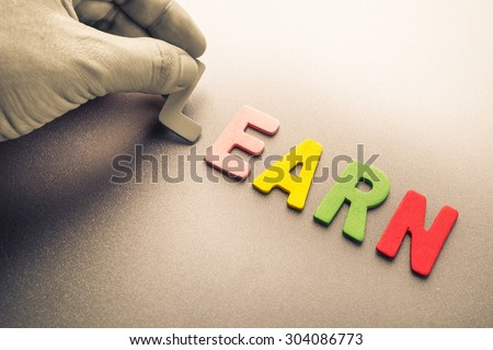 Hand arrange wood letters as Learn word