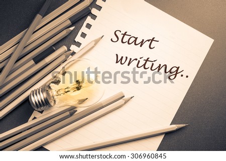 Start Writing as memo on paper with many pencils and light bulb