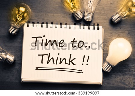 Time To Think, handwriting on notebook with light bulbs