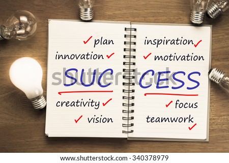 Success factor as memo on notebook with light bulbs